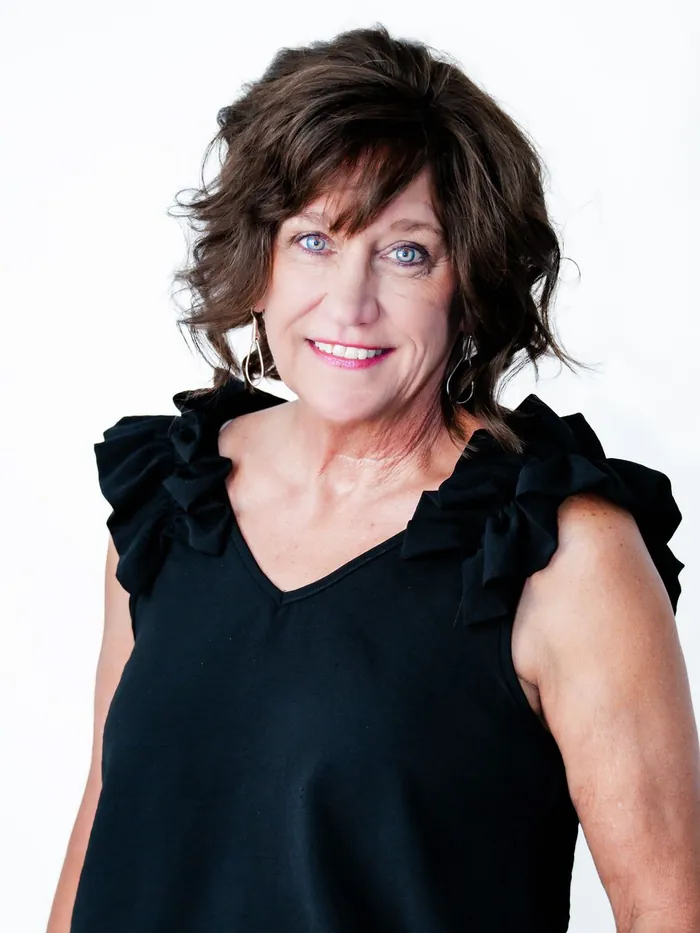 After: a full layered brown cut with complete coverage, same white studio background