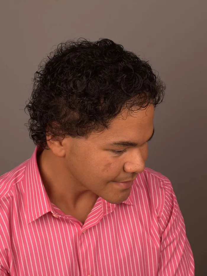 Tight-curl textured mens hair replacement system, three-quarter view