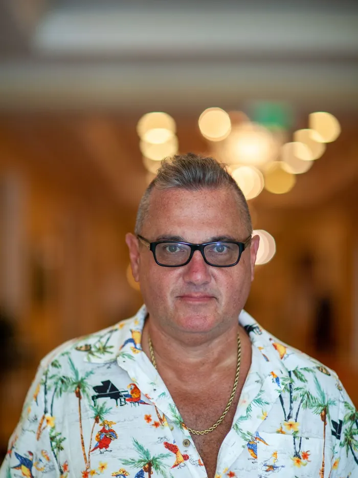 Before: thinning hair on top of a man over 45 wearing glasses, front view